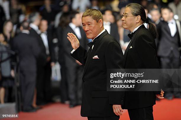 Japanese actor and director Takeshi Kitano and Japanese producer Masayuki Mori arrive for the screening of "Outrage" presented in competition at the...