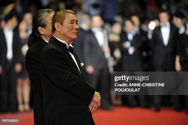 Japanese actor and director Takeshi Kitano and Japanese producer Masayuki Mori arrive for the screening of "Outrage" presented in competition at the...