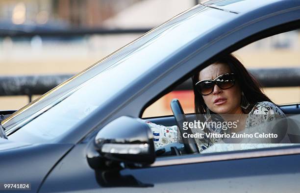Actress Lindsay Lohan departs to attend Press Meeting aboard Lancia "Signora Del Vento" on May 17, 2010 in Cannes, France.