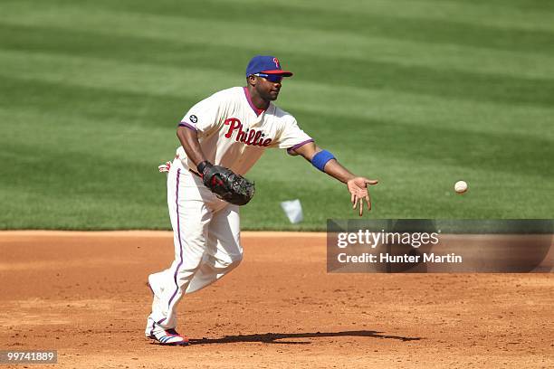 First baseman Ryan Howard of the Philadelphia Phillies flips the ball to first base during a game against the Atlanta Braves at Citizens Bank Park on...