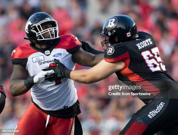 Micah Johnson of the Calgary Stampeders rushes the Ottawa Redblacks line in a regular season Canadian Football League game played at TD Place Stadium...