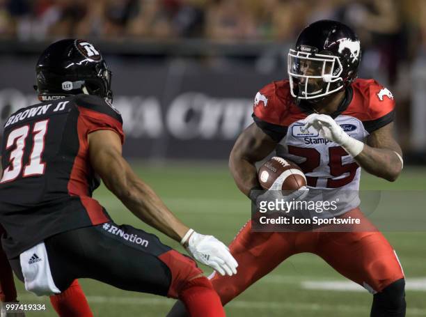 Don Jackson of the Calgary Stampeders tries to fake out the Ottawa Redblacks in a regular season Canadian Football League game played at TD Place...