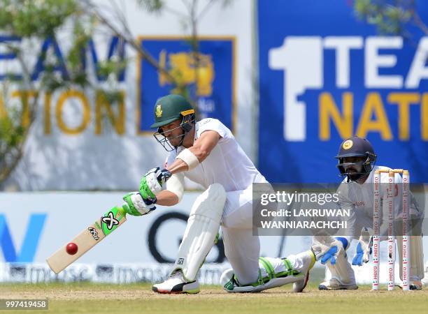 South Africa's captain Faf du Plessis plays a shot in front of Sri Lanka's wicketkeeper Niroshan Dickwella during the second day of the opening Test...