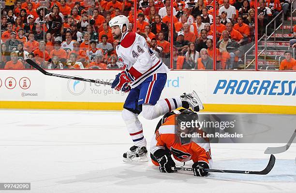 Dan Carcillo of the Philadelphia Flyers battles in the crease against Roman Hamrlik of the Montreal Canadiens in Game One of the Eastern Conference...