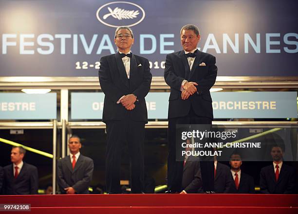 Japanese producer Masayuki Mori and Japanese actor and director Takeshi Kitano arrive for the screening of "Outrage" presented in competition at the...