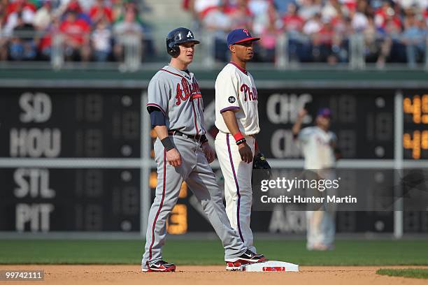 Center fielder Nate McLouth of the Atlanta Braves stands on second base next to shortstop Wilson Valdez of the Philadelphia Phillies at Citizens Bank...