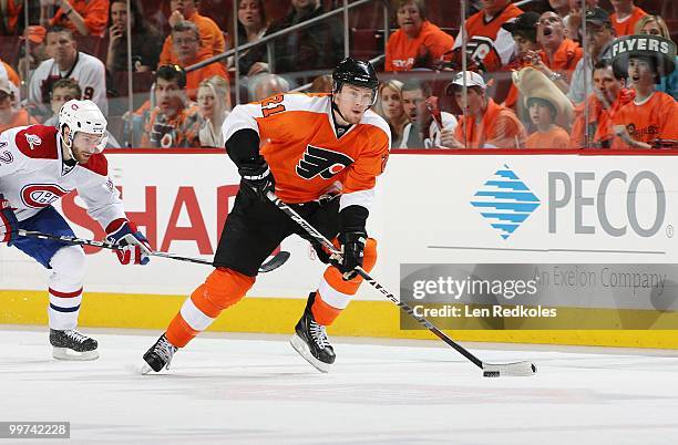 James van Riemsdyk of the Philadelphia Flyers skates with the puck against Dominic Moore of the Montreal Canadiens in Game One of the Eastern...