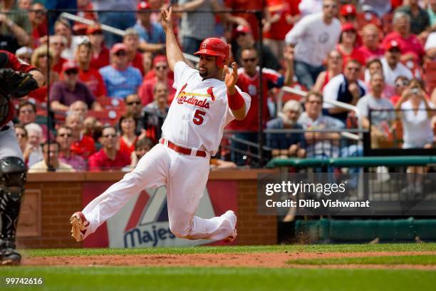Albert Pujols of the St. Louis Cardinals slides into home against the Houston Astros at Busch Stadium on May 13, 2010 in St. Louis, Missouri. The...