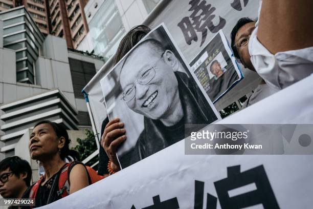 Protesters holding placards of Liu Xiaobo march on a street on July 13, 2018 in Hong Kong, Hong Kong. July 13 marks one year anniversary of late...