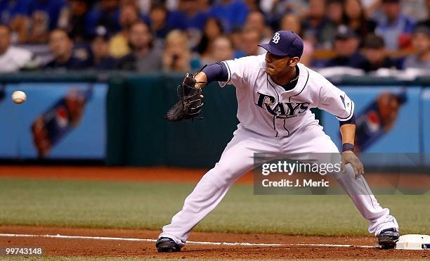 First baseman Carlos Pena of the Tampa Bay Rays takes the throw at first against the Seattle Mariners during the game at Tropicana Field on May 14,...