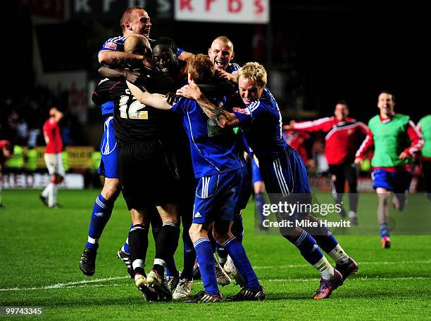 Swindon players mob goalkeeper Phil Smith of Swindon after his penalty save during the Coca-Cola League One Playoff Semi Final 2nd Leg between...