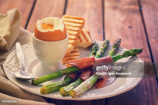 organic asparagus wrapped in prosciutto - prosciutto wrapped stock pictures, royalty-free photos & images