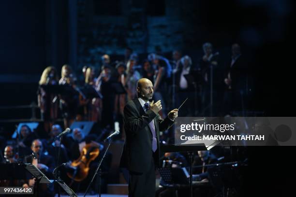 Lebanese artist Hani Siblini conducts the orchestra during Lebanese artist Ziad Rahbani's concert at the Beiteddine Palace in Lebanon's Chouf...