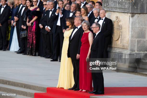 First Lady Melania Trump, U.S. President Donald Trump, British Prime Minister Theresa May and her husband Philip May watch a military band at...