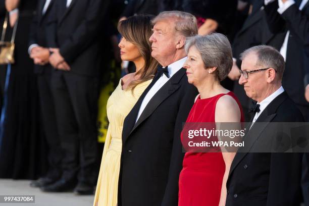 First Lady Melania Trump, U.S. President Donald Trump, British Prime Minister Theresa May and her husband Philip May watch a military band at...