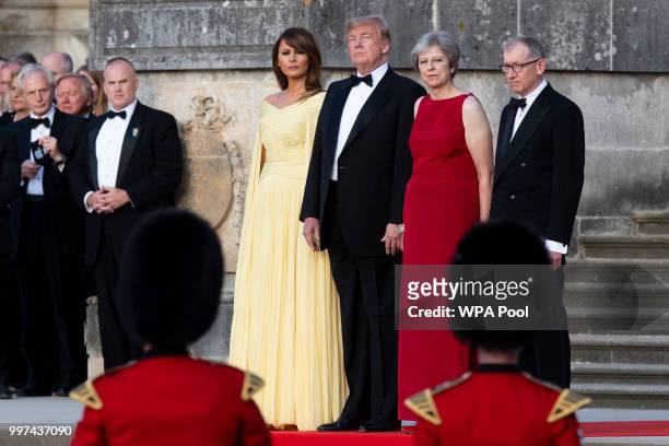 First Lady Melania Trump, U.S. President Donald Trump, British Prime Minister Theresa May and her husband Philip May watch a military band at...