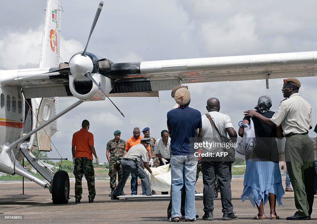 Relatives watch rescue workers as they d