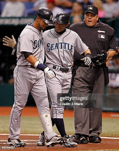 Infielder Ichiro Suzuki of the Seattle Mariners congratulates Franklin Gutierrez after his home run against the Tampa Bay Rays during the game at...