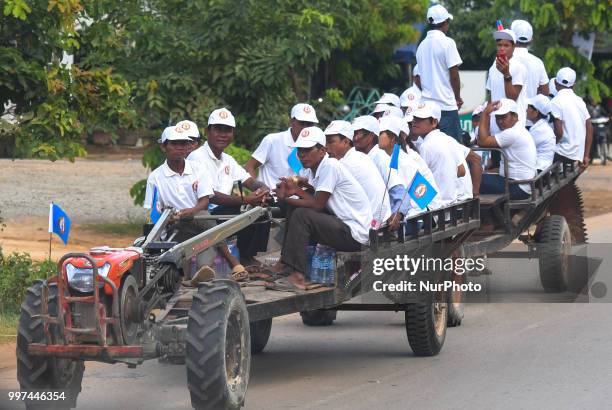 Supporters of the ruling Cambodian People's Party during a party election rally seen on the main road from Siem Reap to Krong Poi Pet, as the general...