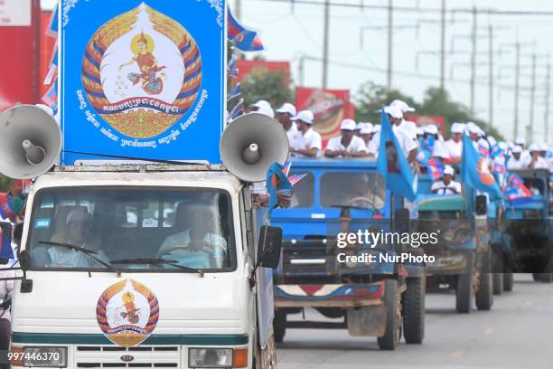 Supporters of the ruling Cambodian People's Party during a party election rally seen on the main road from Siem Reap to Krong Poi Pet, as the general...