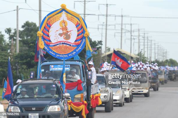 Supporters of the ruling Cambodian People's Party during a party election rally seen on the main road from Siem Reap to Krong Poi Pet, as the general...