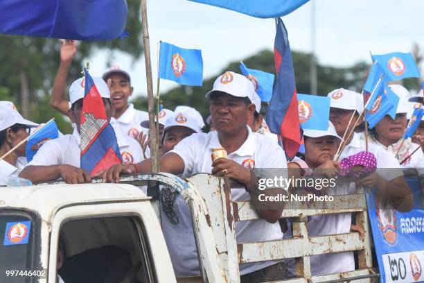 Supporters of the ruling Cambodian People's Party during a party election rally seen on the main road from Siem Reap to Krong Poi Pet, as the general...