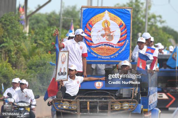 Supporters of the ruling Cambodian People's Party during a party election rally seen on the main road from Siem Reap to Krong Poi Pet, as the general...