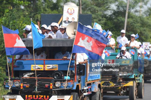 Supporters of the ruling Cambodian People's Party during a party election rally seen on the main road from Siem Reap to Krong Poi Pet, as the general...