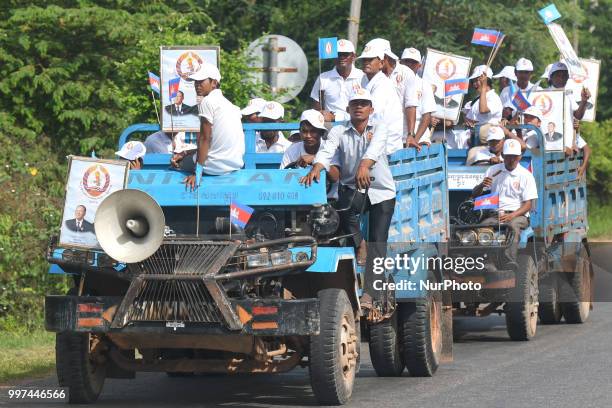 Supporters of the ruling Cambodian People's Party during a party election rally seen on the main road from Siem Reap to Krong Poi Pet, as the general...