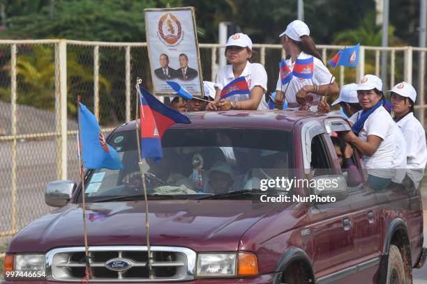 Supporters of the ruling Cambodian People's Party during a party election rally seen on the main road from Siem Reap to Krong Poi Pet, as the general...