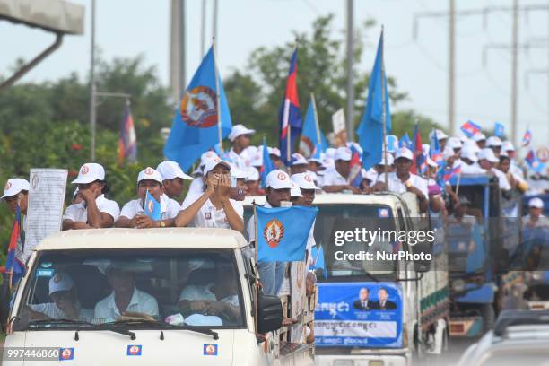 Supporters of the ruling Cambodian People's Party during a party election rally seen on the main road from Siem Reap to Krong Poi Pet, as the general...