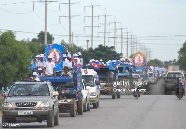 Supporters of the ruling Cambodian People's Party during a party election rally seen on the main road from Siem Reap to Krong Poi Pet, as the general...