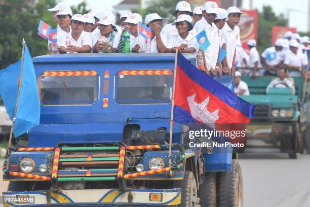 Supporters of the ruling Cambodian People's Party during a party election rally seen on the main road from Siem Reap to Krong Poi Pet, as the general...