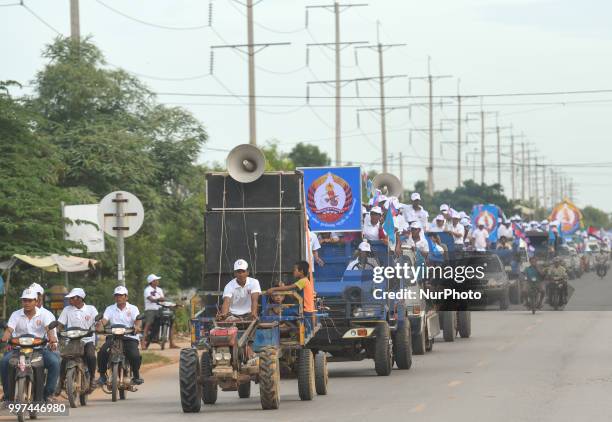 Supporters of the ruling Cambodian People's Party during a party election rally seen on the main road from Siem Reap to Krong Poi Pet, as the general...