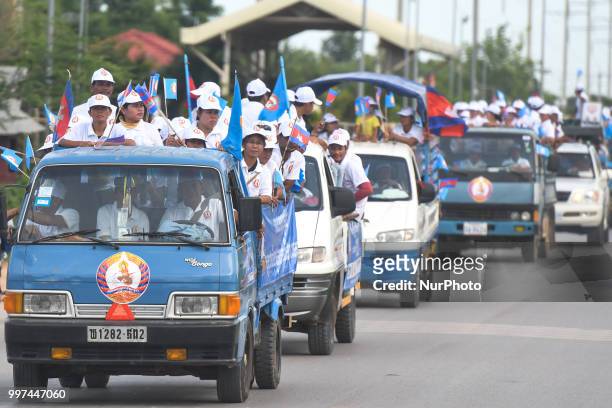 Supporters of the ruling Cambodian People's Party during a party election rally seen on the main road from Siem Reap to Krong Poi Pet, as the general...