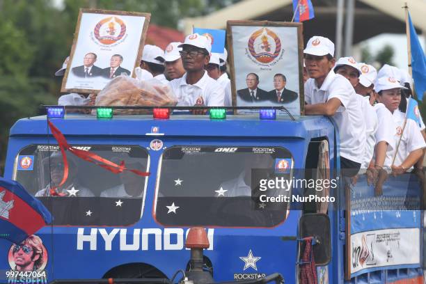 Supporters of the ruling Cambodian People's Party during a party election rally seen on the main road from Siem Reap to Krong Poi Pet, as the general...