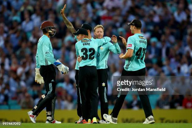 Gareth Batty of Surrey celebrates with his teammates after dismissing Ryan ten Doeschate of Essex during the Vitality Blast match between Surrey and...