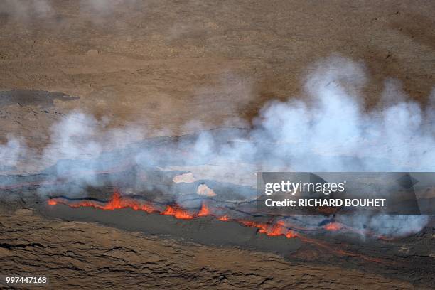 An aerial view taken on July 13 shows steam and lava at the Piton de la Fournaise on the Indian Ocean island of Reunion, which erupted overnight...