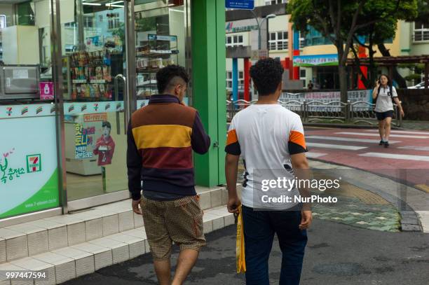 Yemeni asylum seekers walk around Jeju city, in Jeju Island, South Korea on June 27, 2018. More than 550 Yemeni asylum seekers have sparked a...