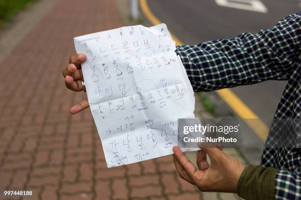 Yemeni refugee learns Hangul from local residents in Jeju city, Jeju Island, South Korea on July 7, 2018. Many Yemeni refugees face difficulties in...