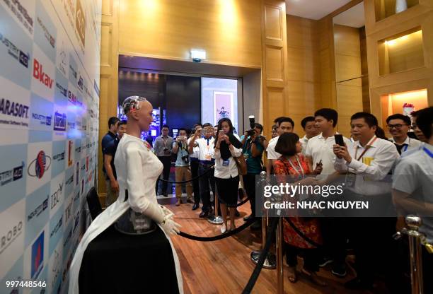 Crowd looks at "Sophia the Robot" created by Hanson Robotics dressed in Ao Dai, a traditional Vietnamese costume during the Industry 4.0 summit on...