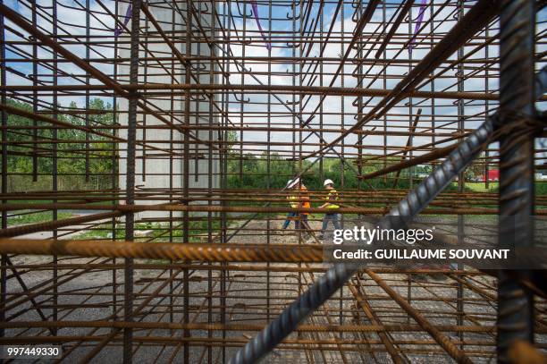 Picture taken on July 12, 2018 shows workers on the construction site of the doubling viaduc of the highway A85 near Langeais. The 653-meter long...
