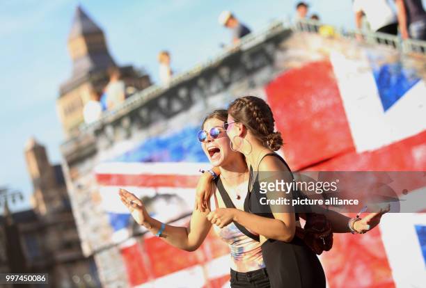 July 2018, Germany, Neustadt-Glewe: Two visitors dancing at the electro music festival 'Airbeat One'. The festival started on Wednesday with the...
