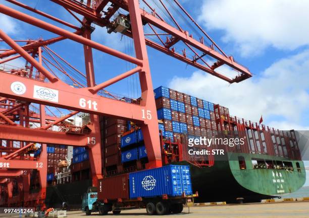 Truck transports containers at a port in Lianyungang in China's eastern Jiangsu province on July 13, 2018. - China's surplus with the United States...