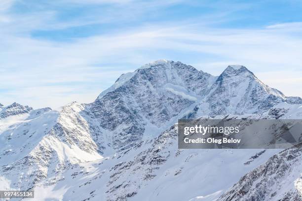 snowed mountain peaks in the caucasus in anticipation of skiers - snowed in stock pictures, royalty-free photos & images