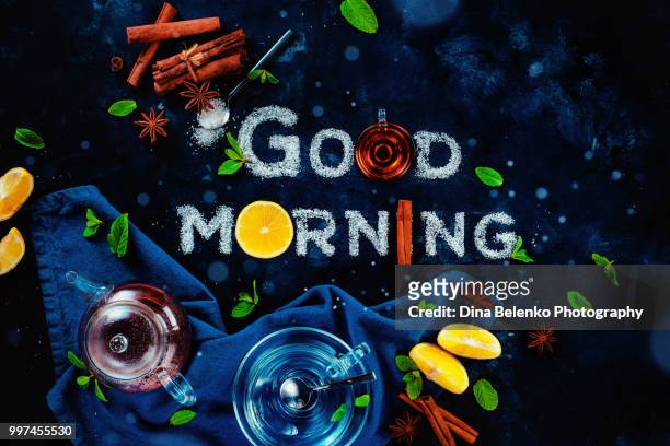 good morning breakfast food typography with tea, mint, lemon, sugar, and cinnamon. food lettering on dark background with hot drinks. - khabarovsk krai stockfoto's en -beelden
