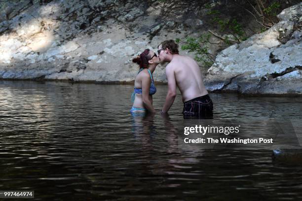 Grace Decker kisses Ronnie Boylen as they cool off in Passage Creek in George Washington National Forest on Wednesday July 11, 2018 in Fort Valley,...