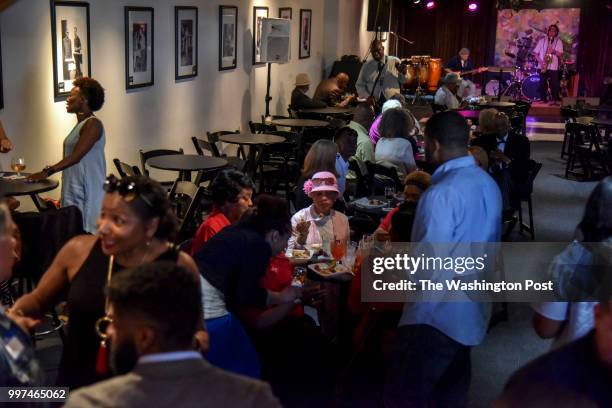 Folks from the community gather at Love's Jazz and Art Center to celebrate the hiring of Dr. Cheyrl Logan, the city's first African American...