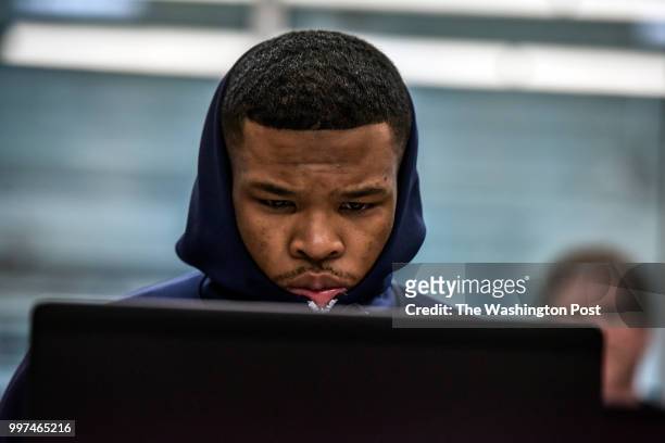 On the first day of a job training program, Isaiah Hall follows a job training presentation on a class-issued laptop at Metropolitan Community...