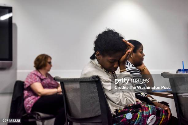 Angelica Dunn holds her weary head in the back of the classroom on the fourth and final day of a job training program at Metropolitan Community...